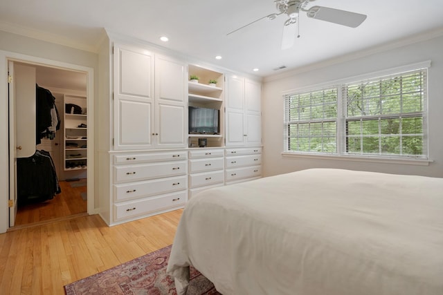 218 Delnor Ave, Saint Charles, IL 60174 - bedroom with ornamental molding, light wood-style flooring, a walk in closet, a ceiling fan, and recessed lighting