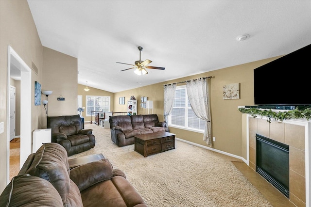 1321 W Ridge Ln, Champaign, IL 61822 - living room with vaulted ceiling, ceiling fan, baseboards, a tile fireplace, and carpet flooring