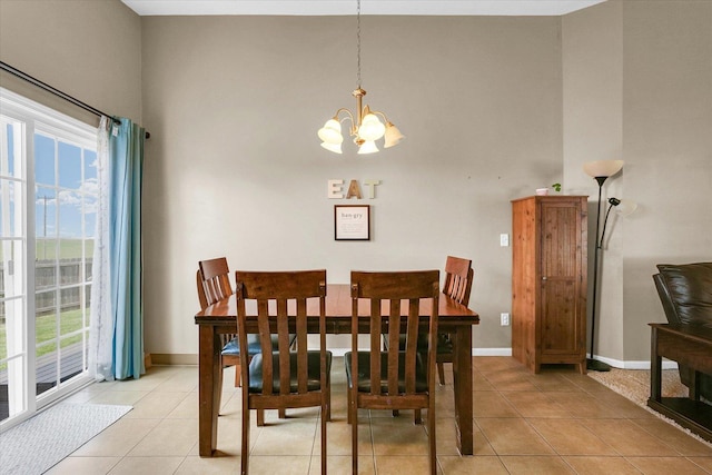 1321 W Ridge Ln, Champaign, IL 61822 - dining area featuring a high ceiling, a chandelier, light tile patterned flooring, and baseboards