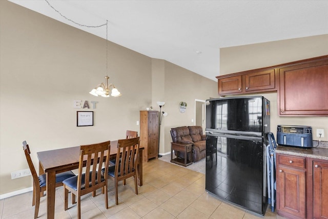 1321 W Ridge Ln, Champaign, IL 61822 - kitchen with freestanding refrigerator, a chandelier, lofted ceiling, light tile patterned flooring, and decorative light fixtures