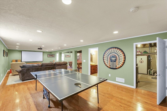 1321 W Ridge Ln, Champaign, IL 61822 - recreation room featuring crown molding, light wood-style flooring, recessed lighting, baseboards, and a textured ceiling