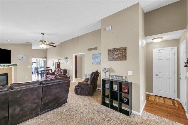1321 W Ridge Ln, Champaign, IL 61822 - living room with ceiling fan, baseboards, a fireplace, carpet, and vaulted ceiling
