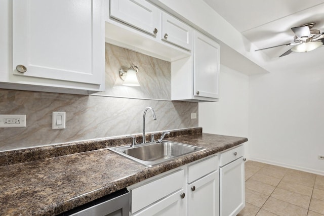 7131 166th St Unit 101, Tinley Park, IL 60477 - kitchen featuring a sink, dark countertops, white cabinetry, and decorative backsplash