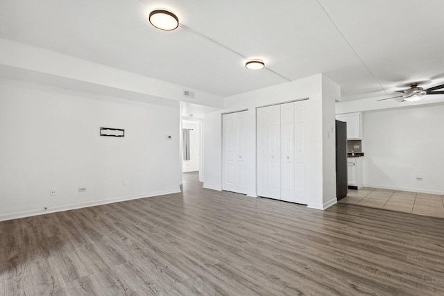 7131 166th St Unit 101, Tinley Park, IL 60477 - unfurnished living room with wood finished floors, ceiling fan, and baseboards