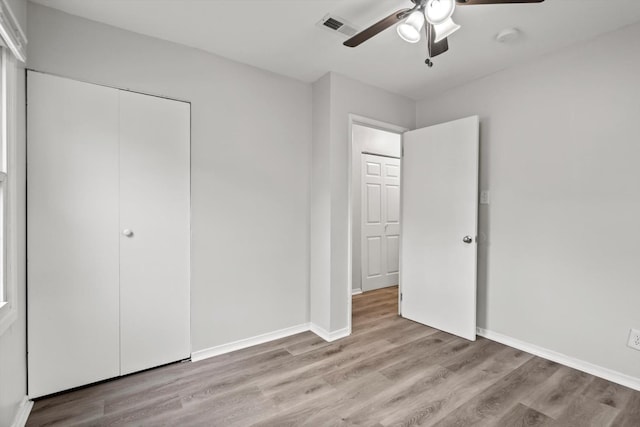 21643 Merrill Ave, Sauk Village, IL 60411 - unfurnished bedroom with light wood-type flooring, a closet, baseboards, and a ceiling fan