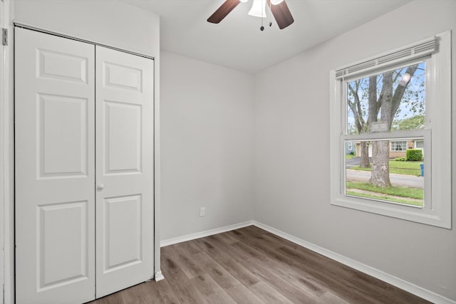 21643 Merrill Ave, Sauk Village, IL 60411 - unfurnished bedroom featuring baseboards, wood finished floors, a closet, and ceiling fan
