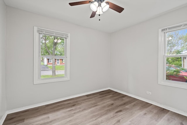 21643 Merrill Ave, Sauk Village, IL 60411 - empty room featuring healthy amount of natural light, wood finished floors, a ceiling fan, and baseboards