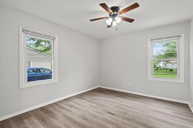 21643 Merrill Ave, Sauk Village, IL 60411 - empty room with plenty of natural light, wood finished floors, and baseboards