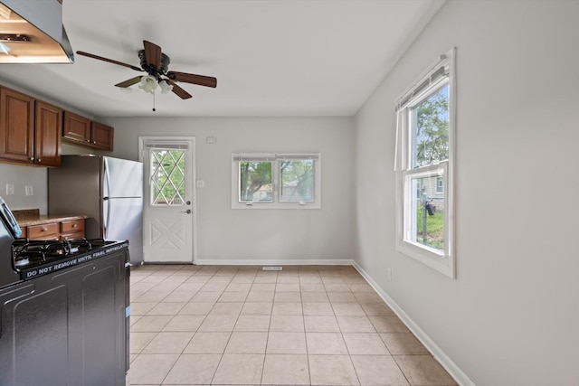 21643 Merrill Ave, Sauk Village, IL 60411 - kitchen with gas stove, extractor fan, a ceiling fan, freestanding refrigerator, and baseboards