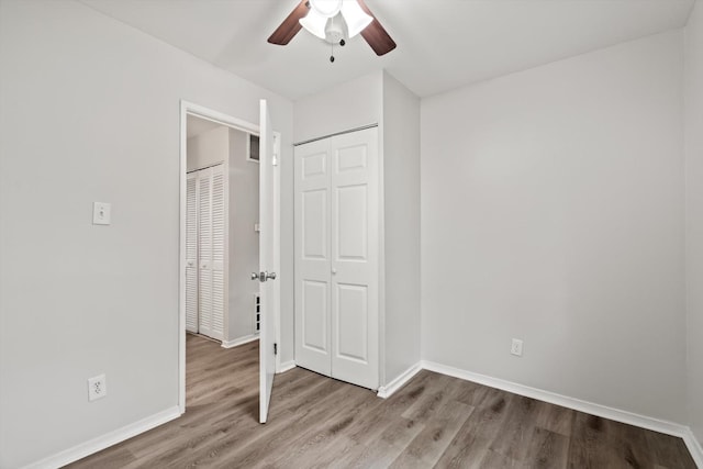 21643 Merrill Ave, Sauk Village, IL 60411 - unfurnished bedroom with wood finished floors, baseboards, a closet, and ceiling fan