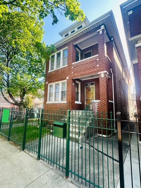 4001 S Albany Ave, Chicago, IL 60632 - view of front facade featuring brick siding, a fenced front yard, and a gate