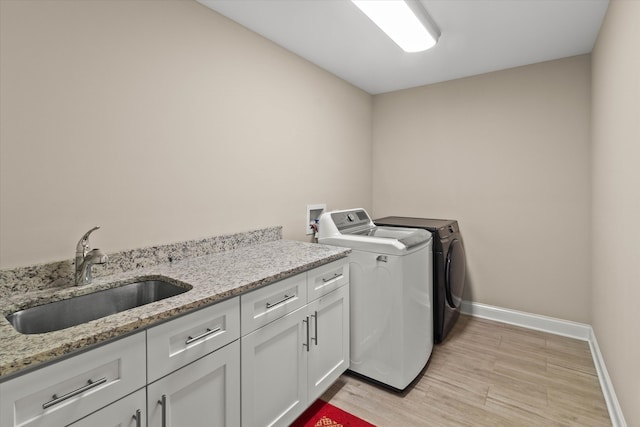 2952 W 100th Pl, Evergreen Park, IL 60805 - washroom with cabinet space, baseboards, independent washer and dryer, and light wood-style flooring