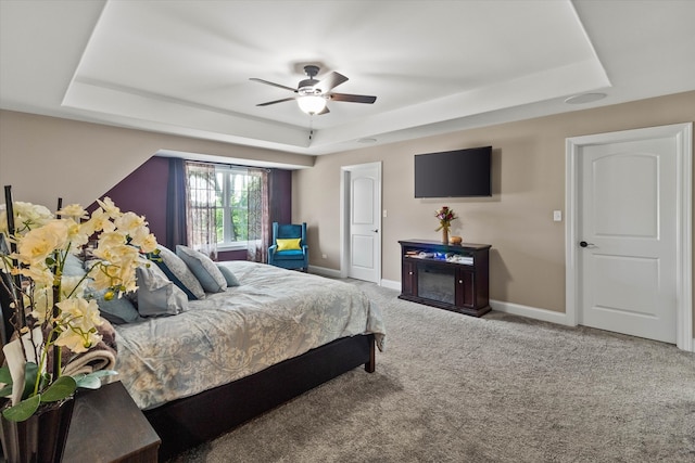 2952 W 100th Pl, Evergreen Park, IL 60805 - carpeted bedroom with a tray ceiling, baseboards, and ceiling fan