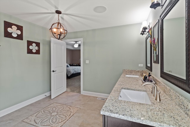 2952 W 100th Pl, Evergreen Park, IL 60805 - bathroom with double vanity, baseboards, connected bathroom, and a chandelier