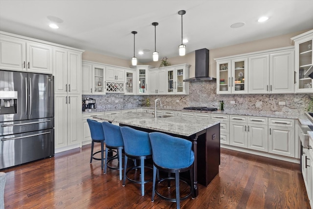2952 W 100th Pl, Evergreen Park, IL 60805 - kitchen featuring appliances with stainless steel finishes, wall chimney exhaust hood, a sink, a kitchen island with sink, and tasteful backsplash