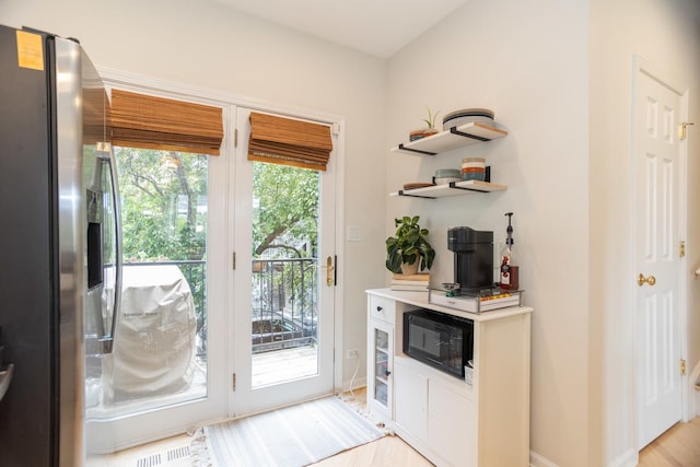 919 W Leland Ave Unit F, Chicago, IL 60640 - doorway to outside with baseboards and light wood-type flooring
