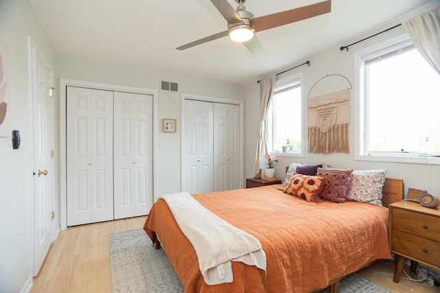 919 W Leland Ave Unit F, Chicago, IL 60640 - bedroom with two closets, light wood-style floors, and a ceiling fan