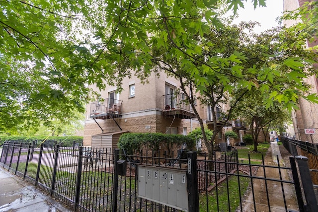 919 W Leland Ave Unit F, Chicago, IL 60640 - view of front of house featuring brick siding and a gate