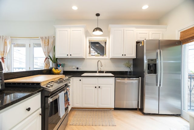 919 W Leland Ave Unit F, Chicago, IL 60640 - kitchen with stainless steel appliances, a sink, white cabinetry, light wood finished floors, and recessed lighting