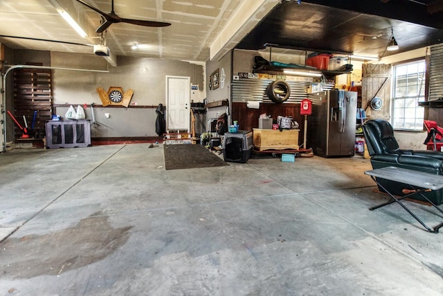 1472 S Saddlebrook Ln, Minooka, IL 60447 - garage featuring stainless steel fridge with ice dispenser, a garage door opener, and a workshop area