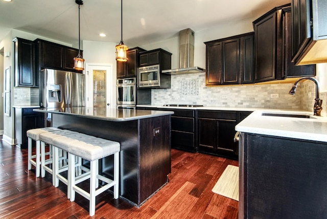 1472 S Saddlebrook Ln, Minooka, IL 60447 - kitchen with wall chimney range hood, a sink, a kitchen island, a kitchen bar, and stainless steel appliances