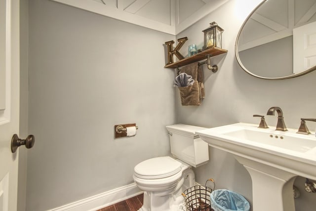 1472 S Saddlebrook Ln, Minooka, IL 60447 - half bathroom featuring toilet, wood finished floors, and baseboards