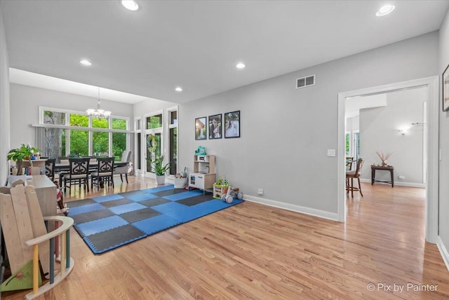 7530 Inverway Dr, Lakewood, IL 60014 - workout area with a chandelier, light wood finished floors, recessed lighting, and baseboards