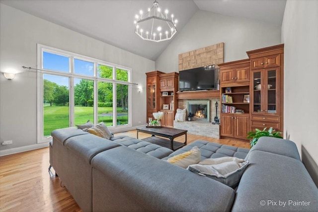 7530 Inverway Dr, Lakewood, IL 60014 - living area featuring high vaulted ceiling, a chandelier, light wood-type flooring, a brick fireplace, and baseboards