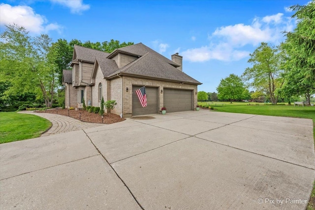 7530 Inverway Dr, Lakewood, IL 60014 - view of property exterior with a garage, concrete driveway, a chimney, a lawn, and a shingled roof