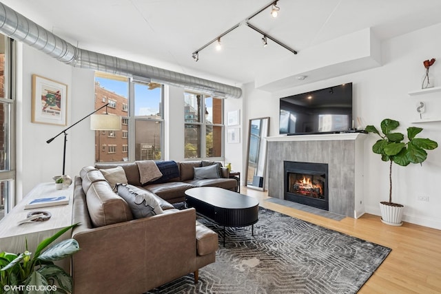 1001 W Madison St Unit 211, Chicago, IL 60607 - living room with wood finished floors, track lighting, a fireplace, and baseboards