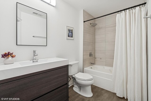 1001 W Madison St Unit 211, Chicago, IL 60607 - bathroom featuring vanity, toilet, shower / bath combo, and wood finished floors
