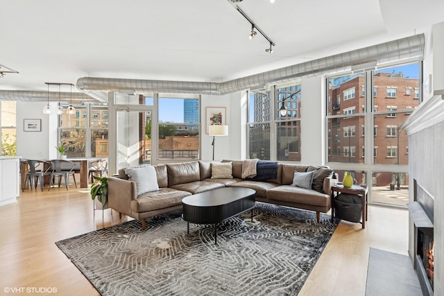 1001 W Madison St Unit 211, Chicago, IL 60607 - living room with wood finished floors, rail lighting, and floor to ceiling windows
