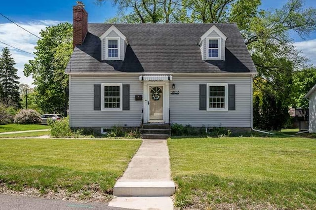 3803 Charles St, Rockford, IL 61108 - cape cod-style house with a front lawn and a chimney