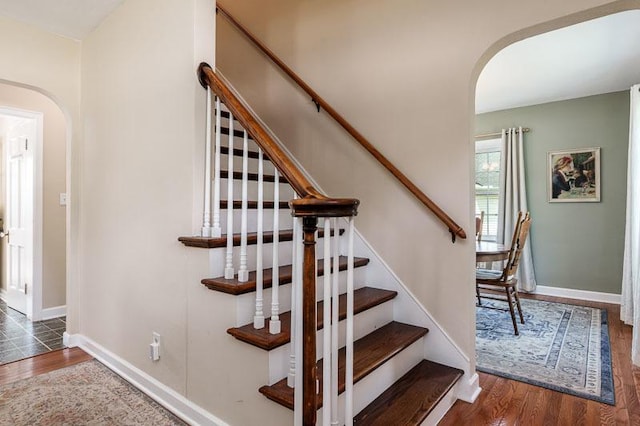 3803 Charles St, Rockford, IL 61108 - staircase with arched walkways, wood finished floors, and baseboards