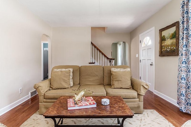 3803 Charles St, Rockford, IL 61108 - living room with arched walkways, baseboards, and wood finished floors