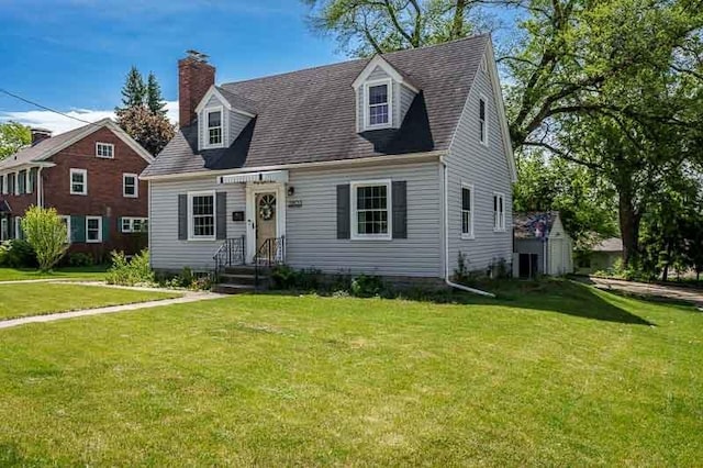3803 Charles St, Rockford, IL 61108 - new england style home featuring a front yard, a chimney, and central AC