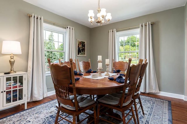 3803 Charles St, Rockford, IL 61108 - dining space with healthy amount of natural light, a chandelier, wood finished floors, and baseboards
