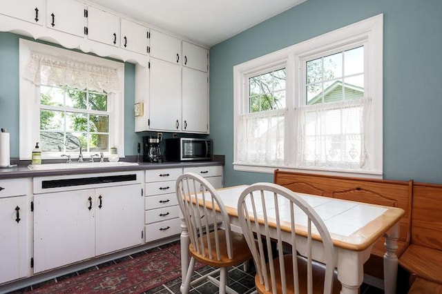 3803 Charles St, Rockford, IL 61108 - kitchen with a sink, stainless steel microwave, healthy amount of natural light, and white cabinets