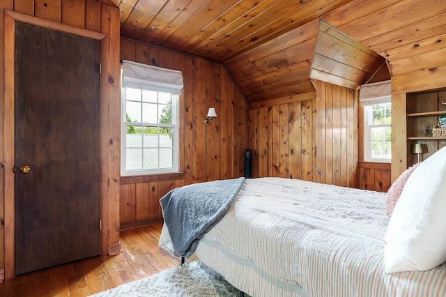 3803 Charles St, Rockford, IL 61108 - bedroom with lofted ceiling, multiple windows, hardwood / wood-style floors, wooden walls, and wood ceiling