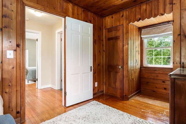 3803 Charles St, Rockford, IL 61108 - bedroom featuring wood-type flooring, wood walls, and baseboards