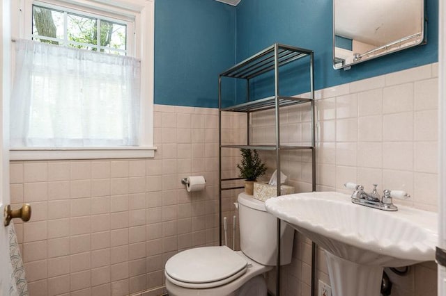 3803 Charles St, Rockford, IL 61108 - bathroom featuring tile walls, toilet, and a wainscoted wall