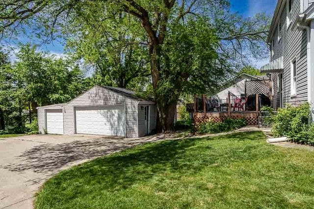 3803 Charles St, Rockford, IL 61108 - view of grassy yard featuring an outdoor structure, a detached garage, and a wooden deck