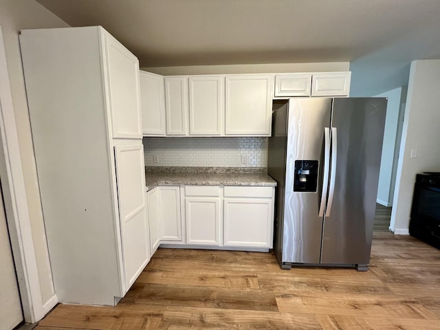 2422 E Washington St, Urbana, IL 61802 - kitchen featuring stainless steel refrigerator with ice dispenser, backsplash, white cabinets, light wood finished floors, and range