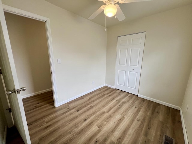 2422 E Washington St, Urbana, IL 61802 - unfurnished bedroom featuring wood finished floors and a ceiling fan
