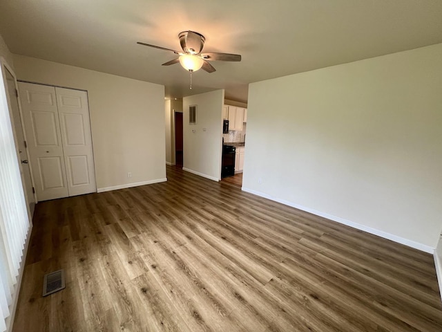 2422 E Washington St, Urbana, IL 61802 - unfurnished living room with ceiling fan and wood finished floors