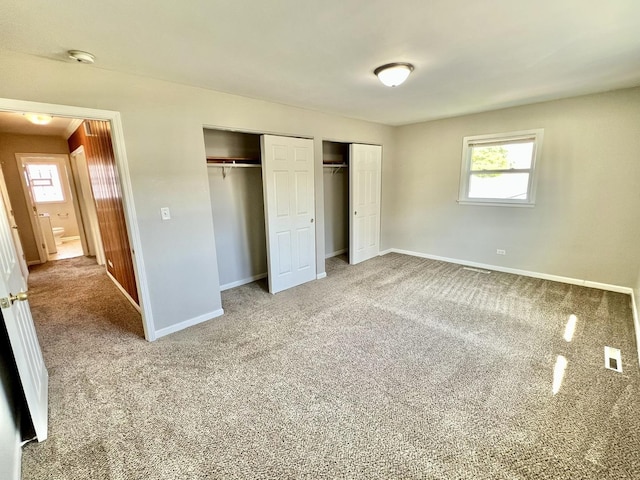 17415 Burnham Ave, Lansing, IL 60438 - unfurnished bedroom featuring carpet floors, baseboards, and two closets
