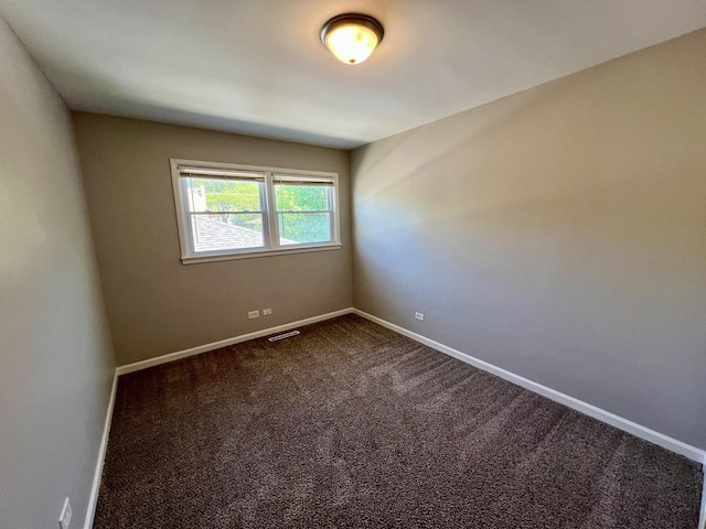 17415 Burnham Ave, Lansing, IL 60438 - empty room featuring dark colored carpet and baseboards