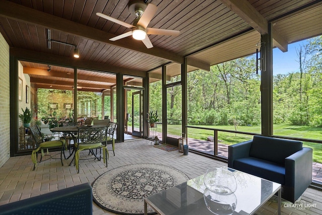5N477 Curling Pond Rd, Wayne, IL 60184 - sunroom / solarium featuring ceiling fan, an outdoor living space, beamed ceiling, outdoor dining area, and a view of trees