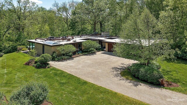 5N477 Curling Pond Rd, Wayne, IL 60184 - mid-century inspired home featuring decorative driveway, a garage, and a front yard