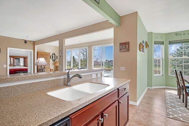814 Glory Ct, Shorewood, IL 60404 - kitchen with a sink, healthy amount of natural light, light tile patterned flooring, and baseboards